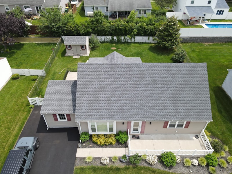 Overhead view of a residential asphalt shingle roof during an inspection.