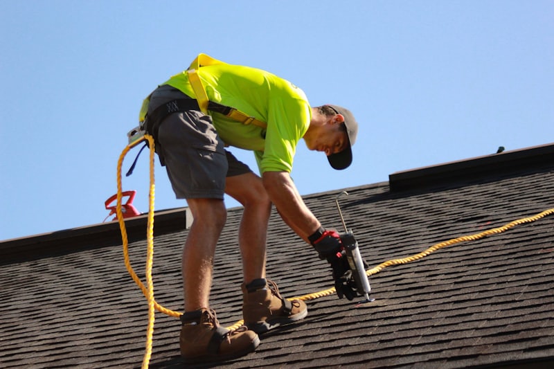 A roofing professional carrying out a repair on a residential roof.